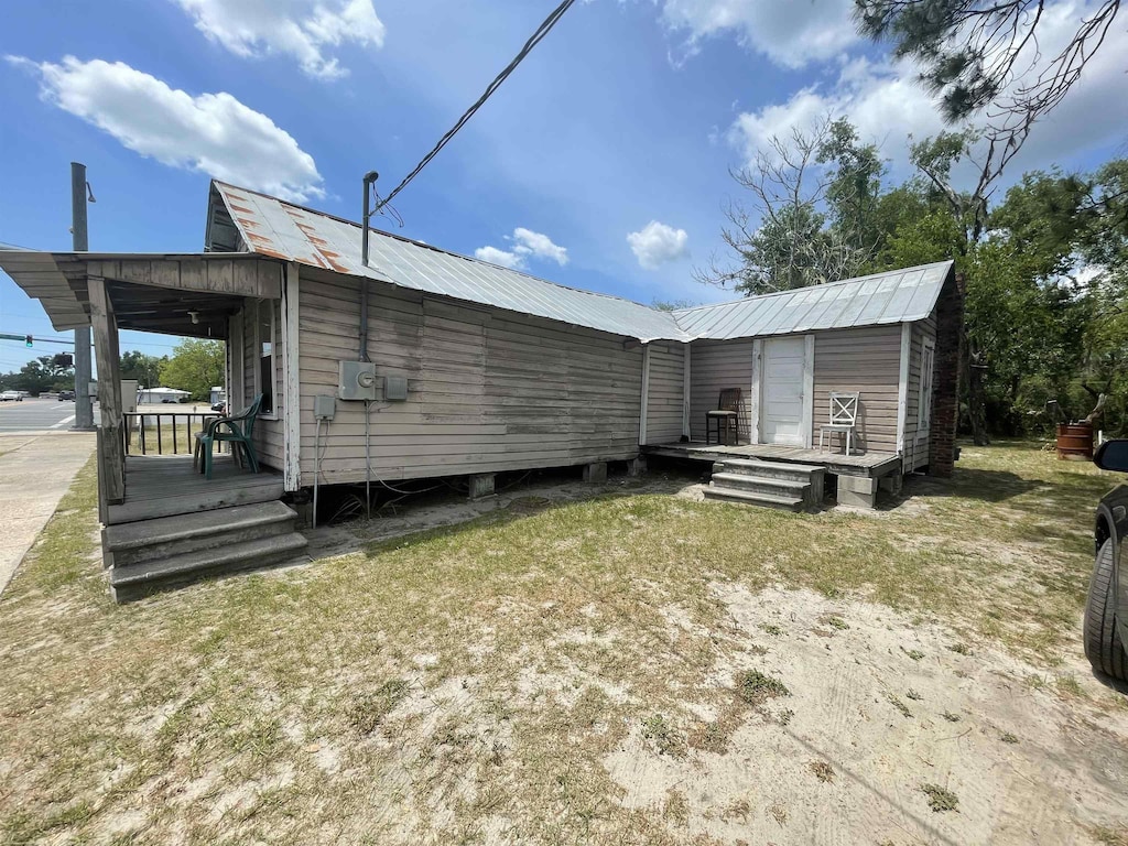 812 Hampton Springs Ave, Perry, FL 32347 - back of house featuring a yard and metal roof