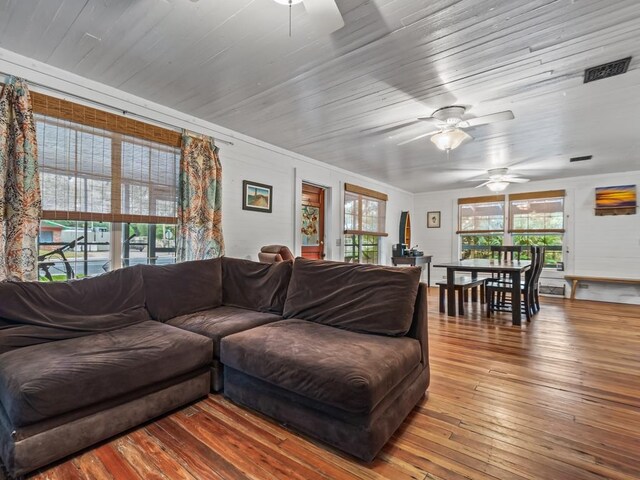 living room featuring ceiling fan and light hardwood / wood-style flooring