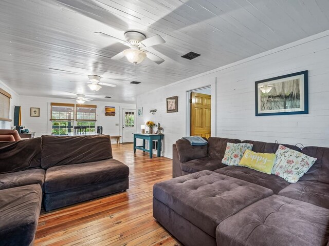 living room featuring ceiling fan and light wood-type flooring