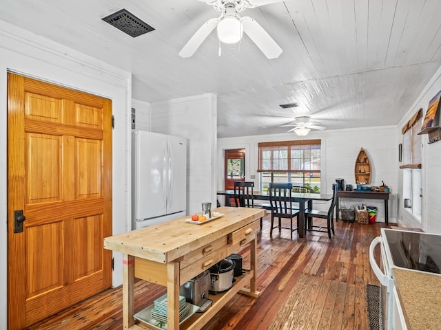 dining space featuring dark hardwood / wood-style floors and wooden walls