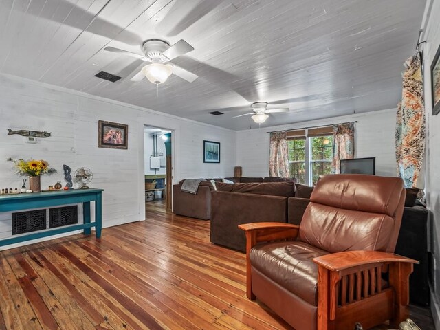 living room featuring hardwood / wood-style flooring and ceiling fan