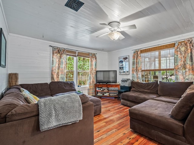 living room with wood walls, light hardwood / wood-style floors, ceiling fan, and wood ceiling