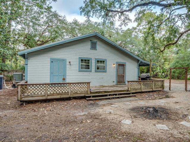 back of house featuring a deck and central air condition unit