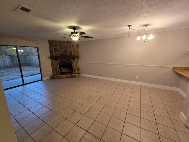 unfurnished living room with ornamental molding, a fireplace, ceiling fan with notable chandelier, and a textured ceiling