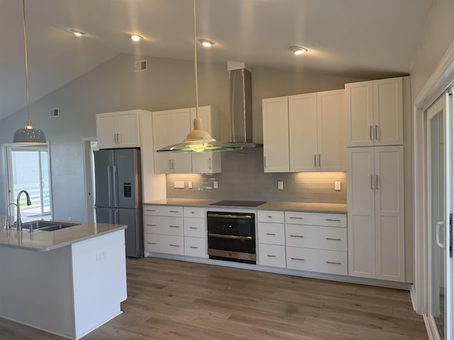kitchen with a sink, white cabinetry, stainless steel appliances, and visible vents