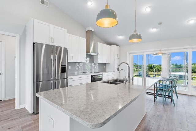 82 Royster Dr, Crawfordville, FL 32327 - kitchen with stainless steel fridge, a sink, lofted ceiling, wall oven, and tasteful backsplash