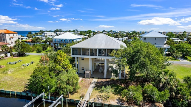 82 Royster Dr, Crawfordville, FL 32327 - back of house with a sunroom, a water view, central AC, boat lift, and a patio area