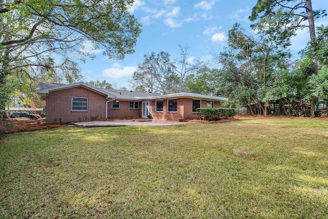 rear view of house featuring a patio and a lawn