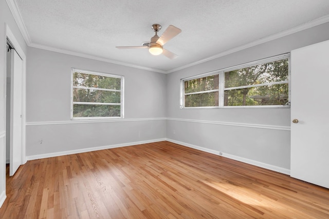 unfurnished room with crown molding, ceiling fan, light hardwood / wood-style floors, and a textured ceiling