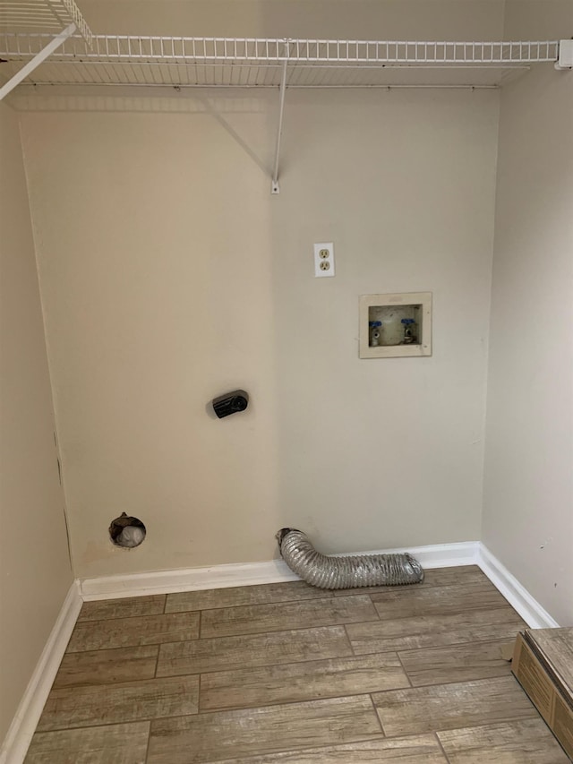 laundry room featuring hookup for a washing machine, laundry area, wood finished floors, baseboards, and electric dryer hookup