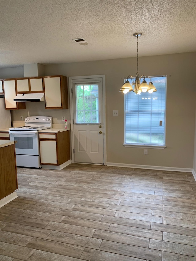 kitchen with a notable chandelier, light wood finished floors, white range with electric cooktop, light countertops, and extractor fan