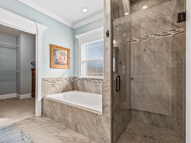 bathroom featuring ornamental molding and independent shower and bath