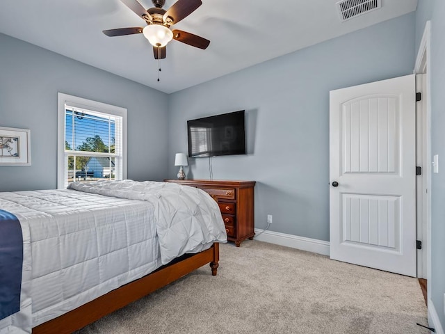 bedroom with light colored carpet and ceiling fan