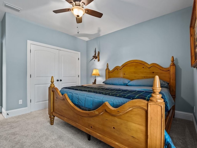 carpeted bedroom with ceiling fan and a closet