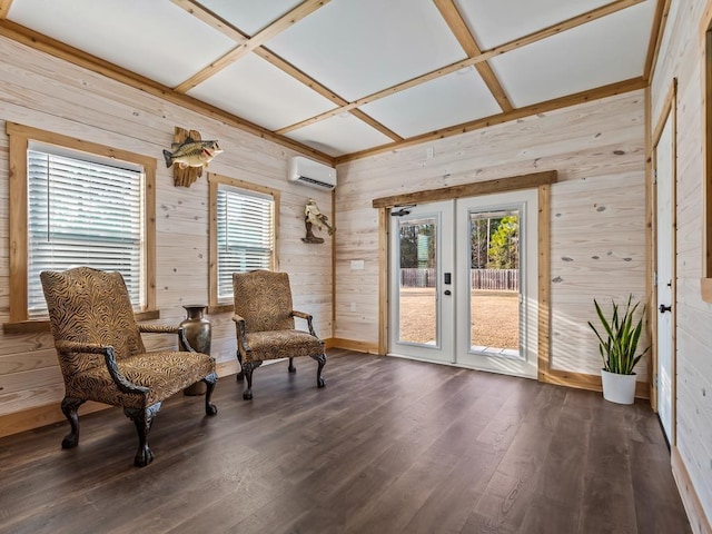 sitting room with wooden walls, a wall mounted AC, coffered ceiling, dark hardwood / wood-style flooring, and french doors