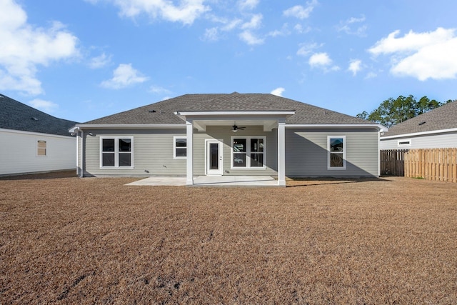 rear view of property featuring ceiling fan and a patio area