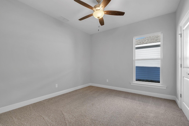 carpeted spare room featuring ceiling fan