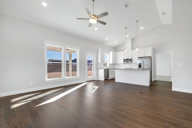 unfurnished living room featuring lofted ceiling, dark hardwood / wood-style floors, and ceiling fan