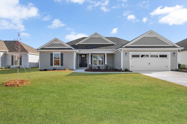 view of front of house featuring a garage and a front lawn