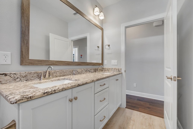 bathroom with vanity and hardwood / wood-style floors