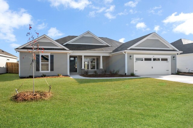 view of front of property with a garage and a front lawn