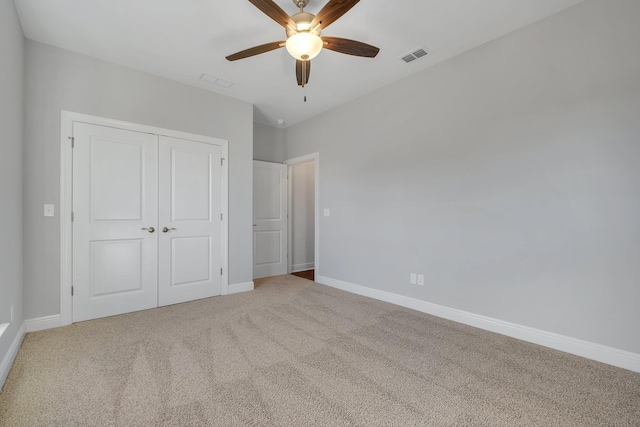 unfurnished bedroom featuring a closet, ceiling fan, and carpet