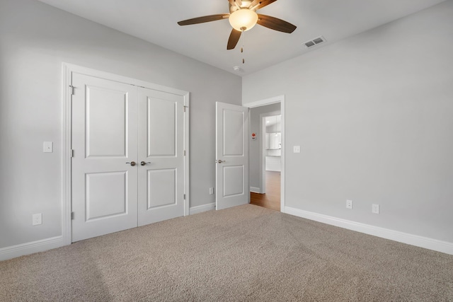 unfurnished bedroom featuring a closet, ceiling fan, and carpet flooring