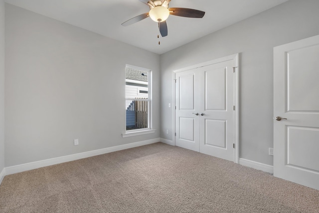 unfurnished bedroom with a closet, ceiling fan, and carpet flooring