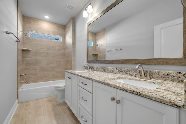 full bathroom featuring tiled shower / bath, vanity, toilet, and wood-type flooring