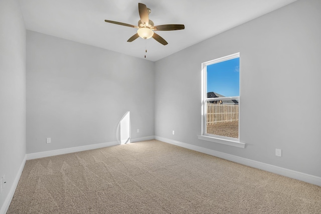 spare room with ceiling fan and carpet