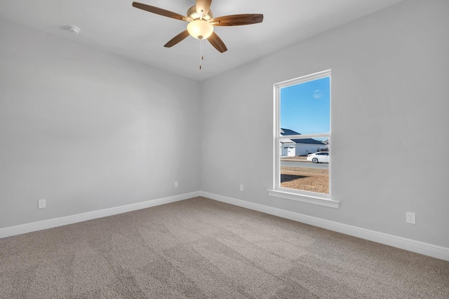 spare room with carpet and ceiling fan