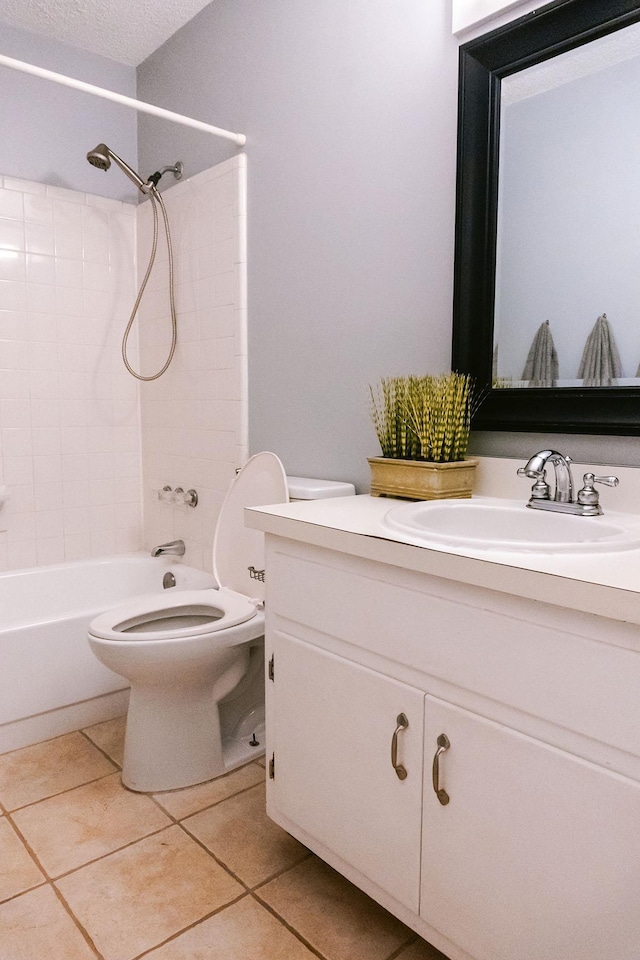 bathroom with a textured ceiling, tile patterned flooring, toilet, vanity, and shower / bathing tub combination