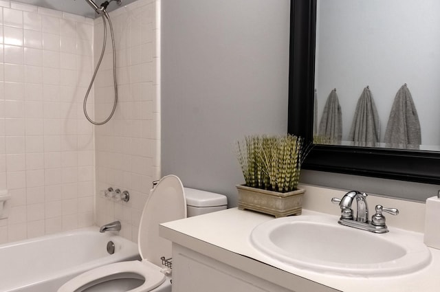 bathroom featuring  shower combination, vanity, and toilet