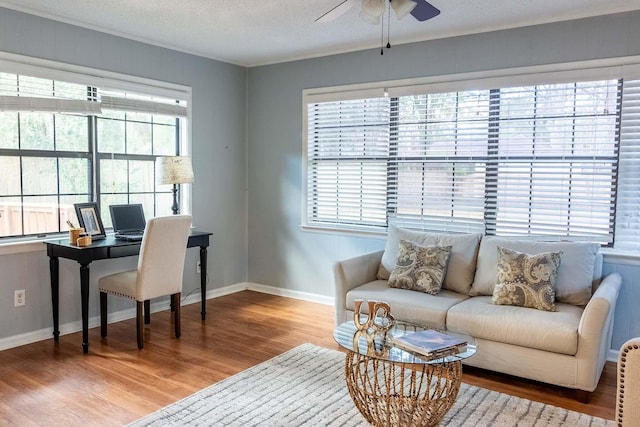 home office with baseboards, a textured ceiling, a ceiling fan, and wood finished floors