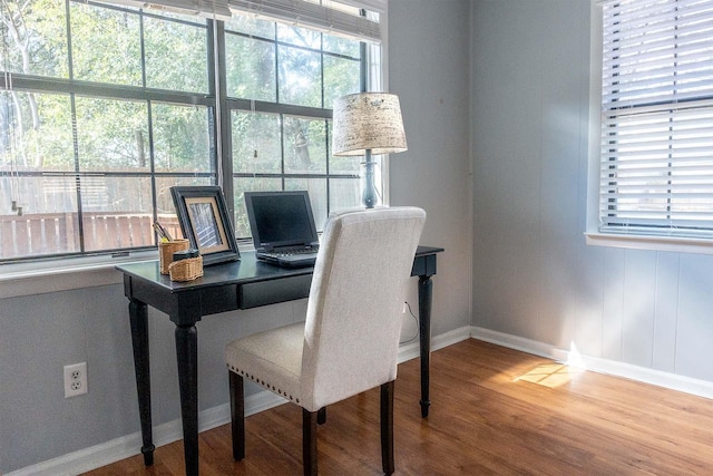 office area featuring a wealth of natural light, baseboards, and wood finished floors