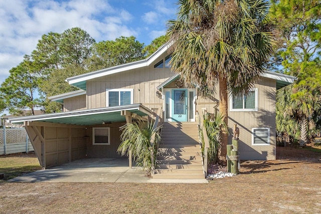 back of house with a carport