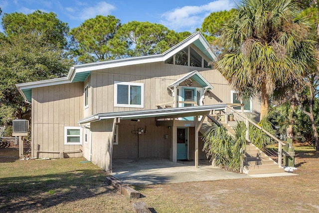 view of front facade with central AC unit and a carport