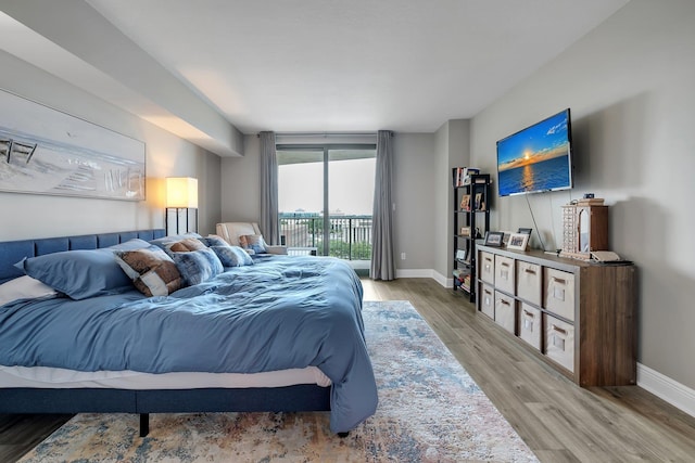 300 S Duval St # 1408, Tallahassee, FL 32301 - bedroom featuring access to outside, wood finished floors, and baseboards
