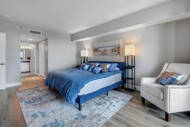 300 S Duval St # 1408, Tallahassee, FL 32301 - bedroom with light wood-type flooring, baseboards, and ensuite bathroom