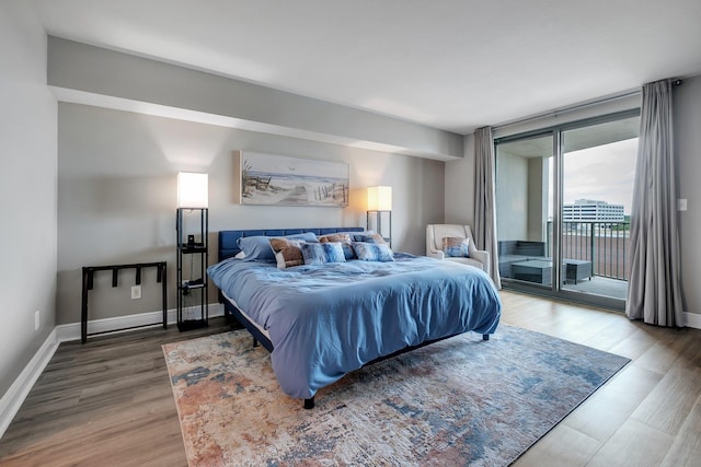 300 S Duval St # 1408, Tallahassee, FL 32301 - bedroom featuring access to exterior, wood finished floors, and baseboards