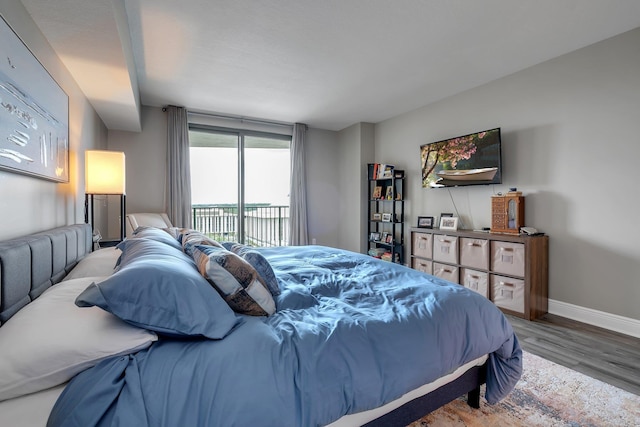 300 S Duval St # 1408, Tallahassee, FL 32301 - bedroom featuring access to outside, wood finished floors, and baseboards