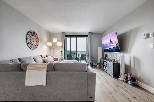 300 S Duval St # 1408, Tallahassee, FL 32301 - living area with light wood-style flooring and baseboards