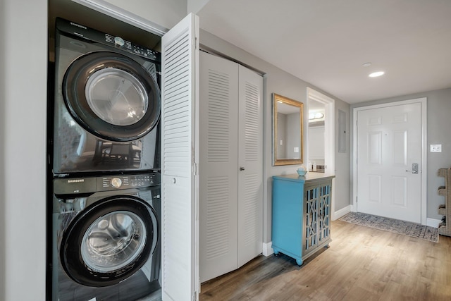 300 S Duval St # 1408, Tallahassee, FL 32301 - laundry room with stacked washer and clothes dryer, wood finished floors, and baseboards