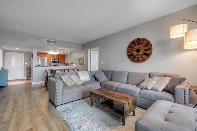 300 S Duval St # 1408, Tallahassee, FL 32301 - living room with light wood-style flooring and rail lighting