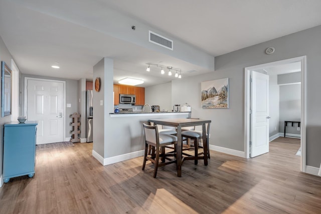 300 S Duval St # 1408, Tallahassee, FL 32301 - dining area with baseboards and light wood-type flooring