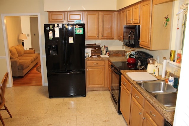 1082 Richardson Rd, Tallahassee, FL 32301 - kitchen featuring black appliances, brown cabinets, and light flooring