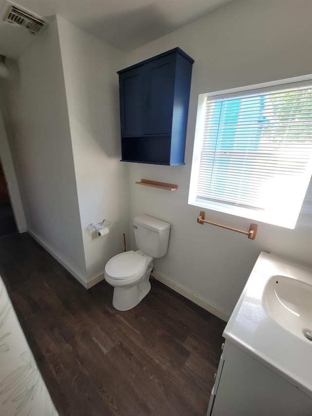 16619 SW Gaskin St, Blountstown, FL 32424 - half bathroom with wood finished floors, toilet, baseboards, and vanity