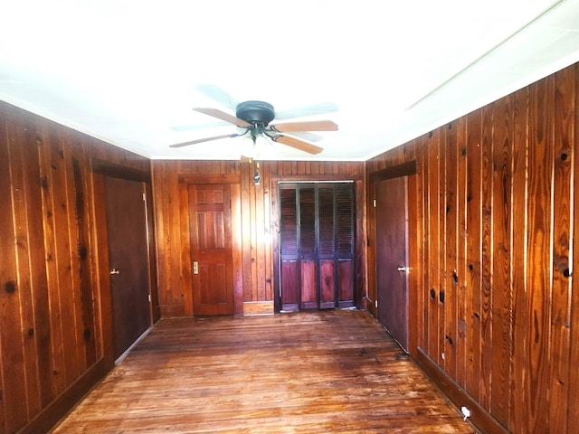 16619 SW Gaskin St, Blountstown, FL 32424 - empty room featuring wooden walls, a ceiling fan, and wood finished floors