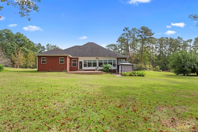 rear view of house featuring a lawn