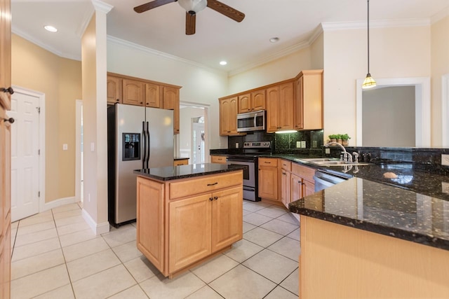 kitchen featuring appliances with stainless steel finishes, hanging light fixtures, sink, and light tile patterned floors